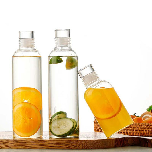 Three glass bottles filled with fruit-infused water.