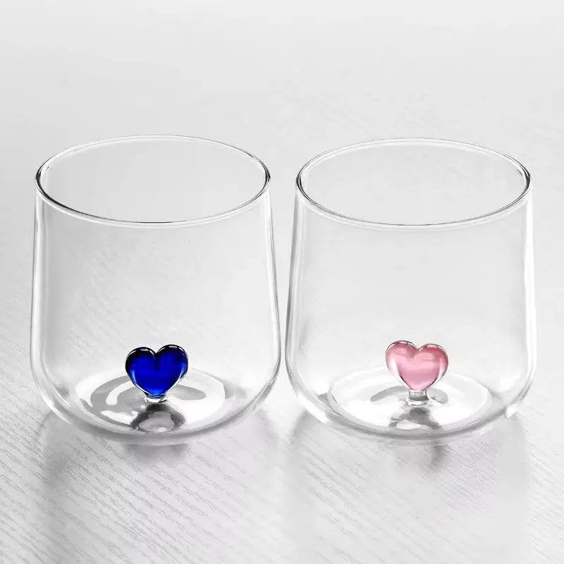 Two clear glasses with heart-shaped bottoms.