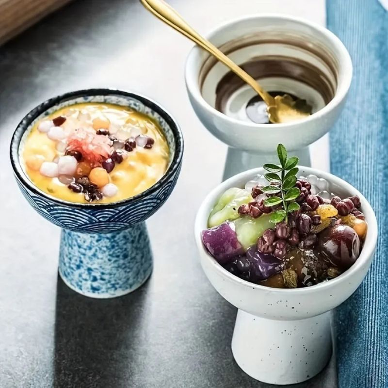 Colorful Asian dessert bowls with toppings like red beans, taro balls, and chewy mochi pearls. Served in elegant pedestal bowls with a gold spoon, creating a refined café presentation.