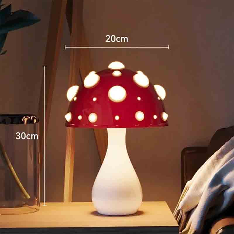 A mushroom-shaped lamp with a red cap and white spots, on a table, with height and width measurements indicated.