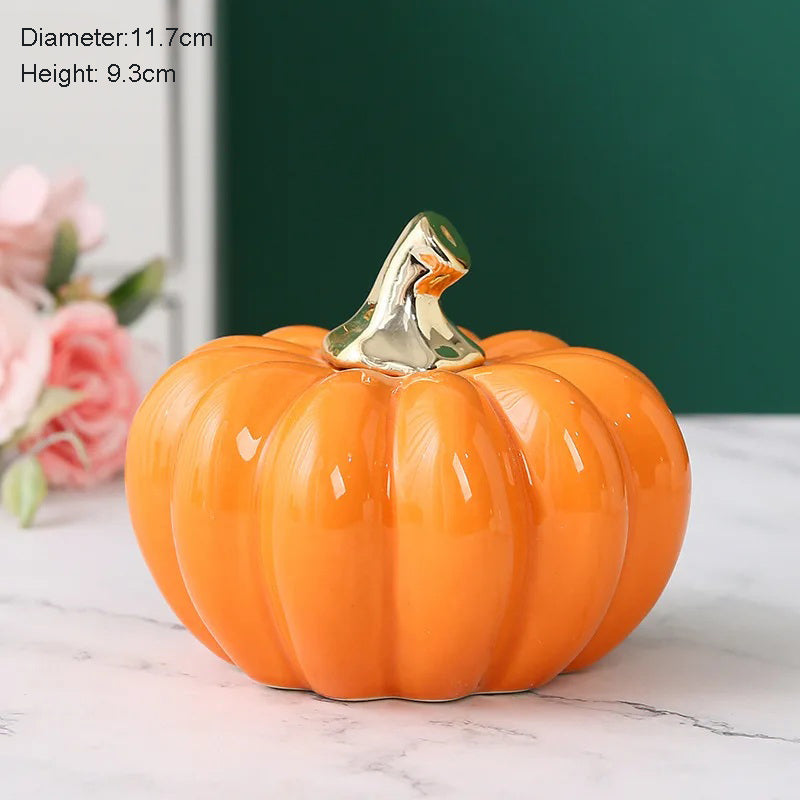 An orange ceramic pumpkin with a gold stem.