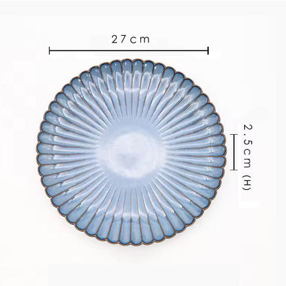 A blue ceramic plate with its dimensions labeled as 27 cm wide and 2.5 cm high.