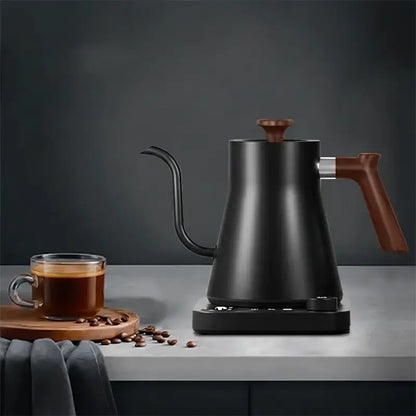 A black gooseneck kettle, a cup of coffee, and coffee beans.