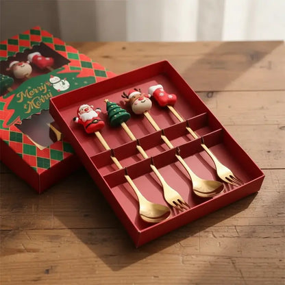 A set of Christmas-themed spoons and forks in a red gift box.