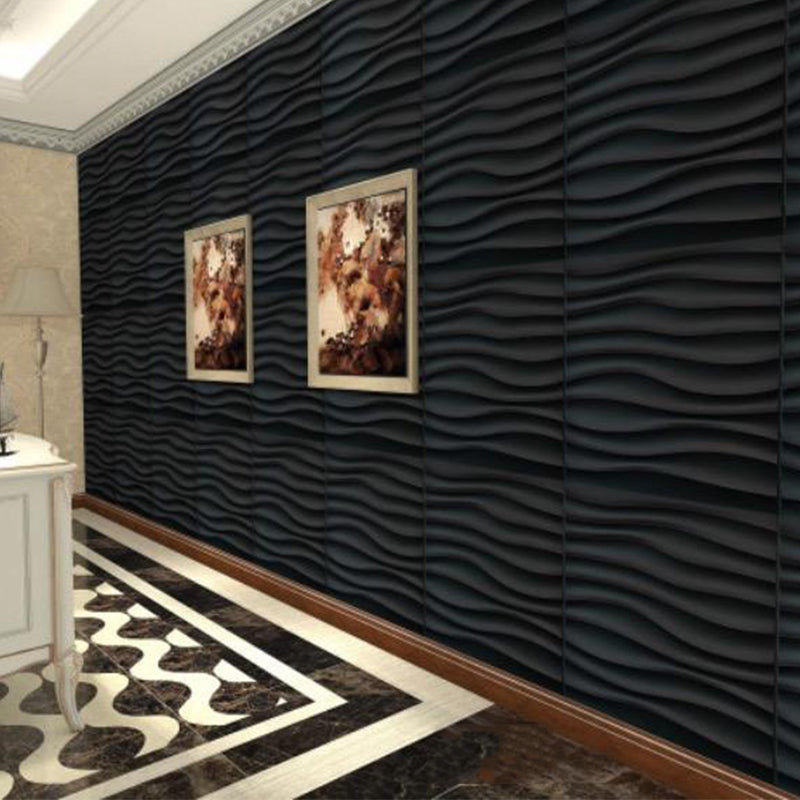 A hallway with a dark wavy textured accent wall, two framed pictures, a white console table, and a black and white patterned floor.
