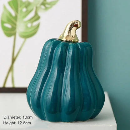 A teal ceramic pumpkin with a gold stem.
