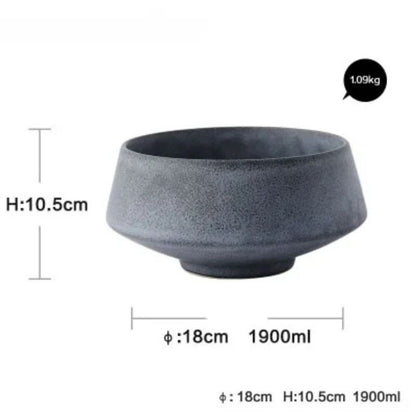 A dark gray porcelain bowl with a frosted texture, featuring a wide, rounded design. The bowl measures 4.1 inches (10.5 cm) in height and 7.1 inches (18 cm) in diameter, with a capacity of 1900 ml. Weight: 1.09 kg.