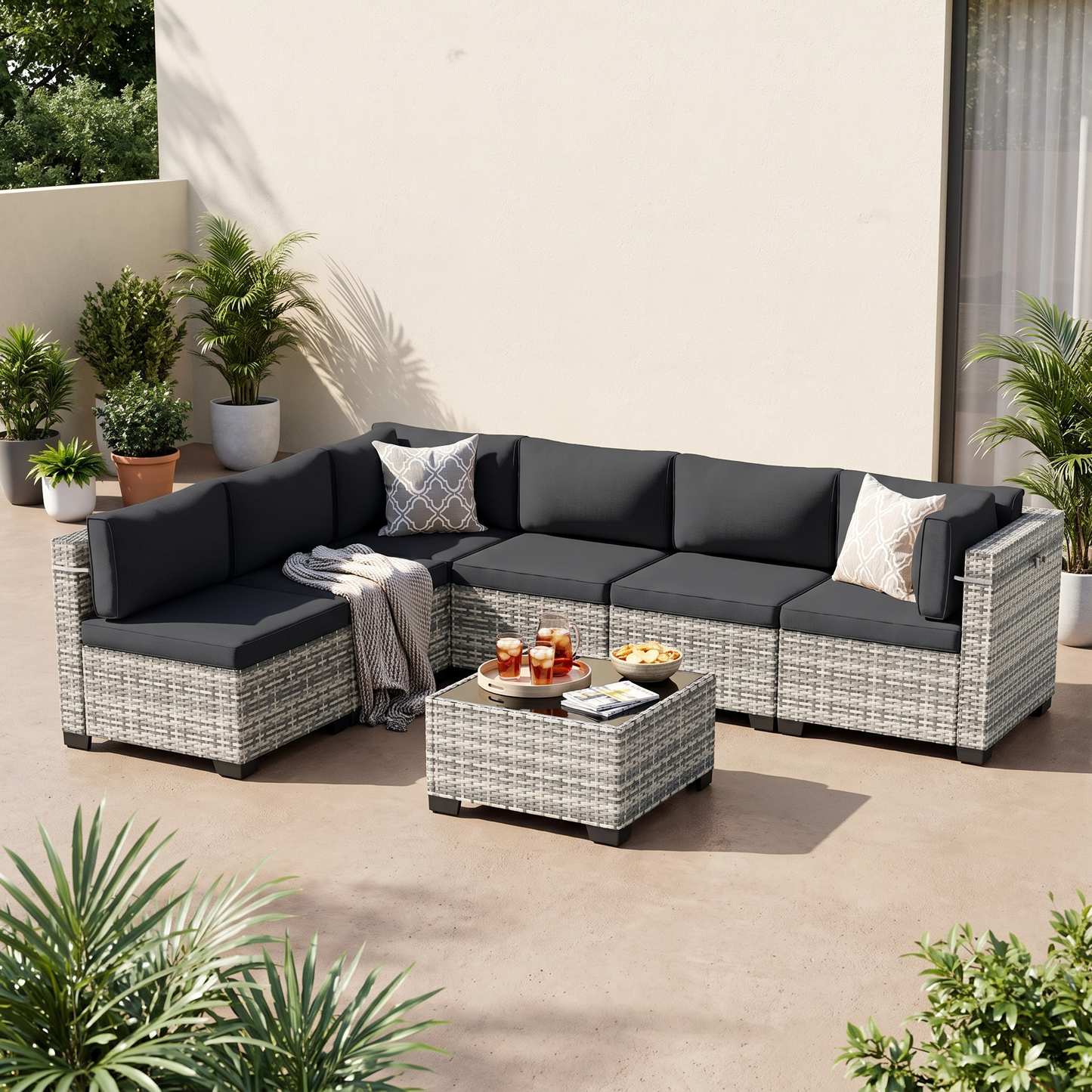Black-cushion 7-piece wicker outdoor sectional on a covered patio