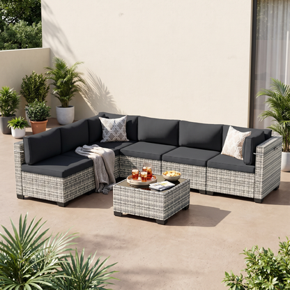 Black-cushion 7-piece wicker outdoor sectional on a covered patio