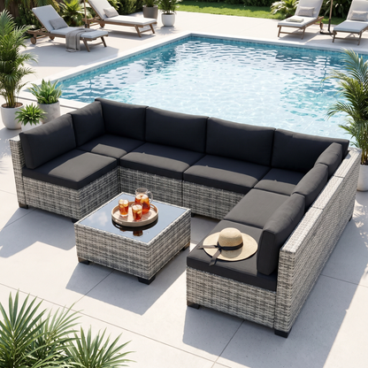 Black-cushion 7-piece wicker outdoor sectional by a swimming pool