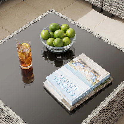 Close-up of the tempered-glass coffee table top on the gray wicker outdoor sectional