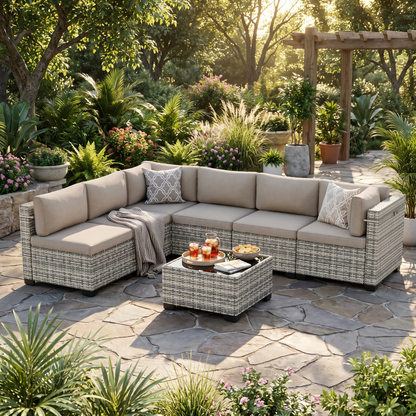 Gray-cushion 7-piece wicker outdoor sectional with coffee table on a garden patio