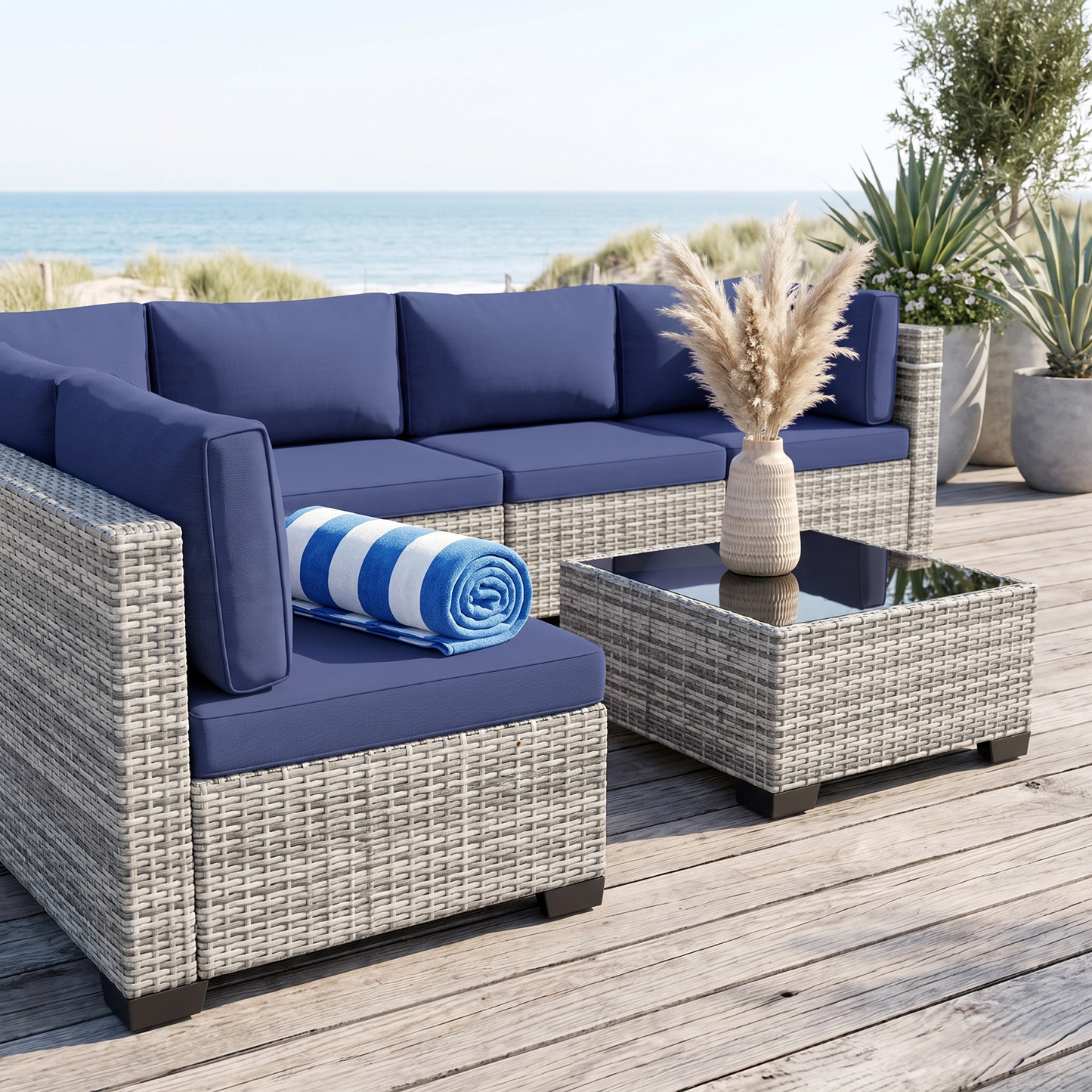 Navy blue cushion 7-piece wicker outdoor sectional on a coastal deck with ocean view
