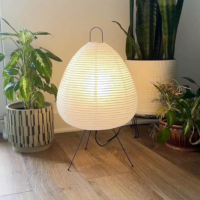 The Akari lamp glowing softly with its rice paper shade, casting a warm, diffused light that enhances any room with serene ambiance.