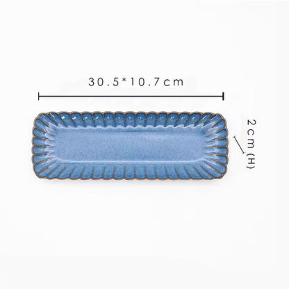 A blue rectangular ceramic plate with its dimensions labeled as 30.5 x 10.7 cm and 2 cm high.