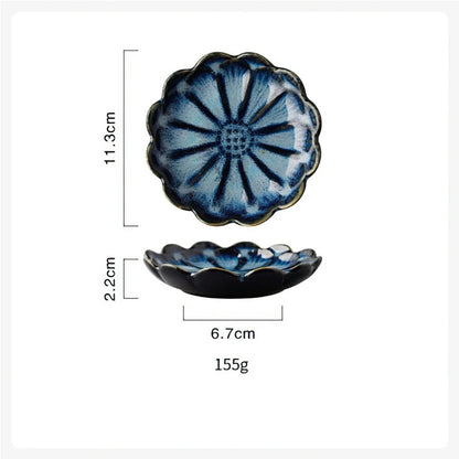 Dimensions diagram for a blue, flower-shaped condiment dish showing a length of 11.3cm, height of 2.2cm, bottom width of 6.7cm, and weight of 155g.