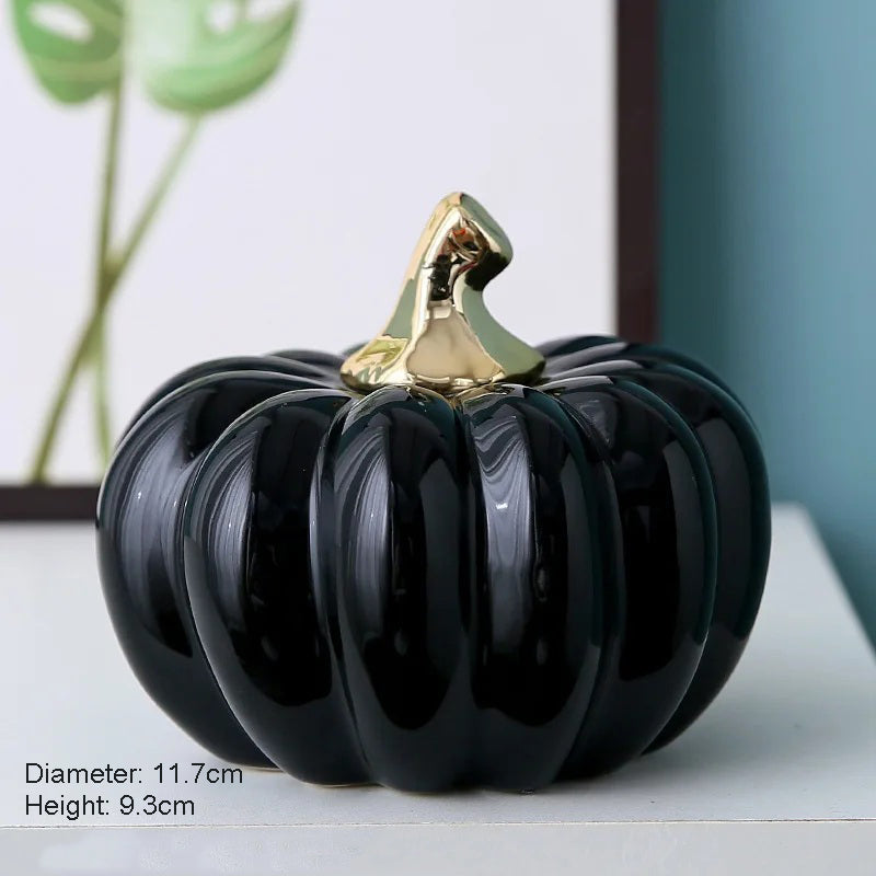A black ceramic pumpkin with a gold stem.