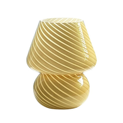 A striped glass mushroom lamp in a warm amber tone, isolated on a white background. The lamp features an elegant, curved design with diagonal stripes, giving it a modern and artistic aesthetic. Ideal for cozy ambient lighting in any space.