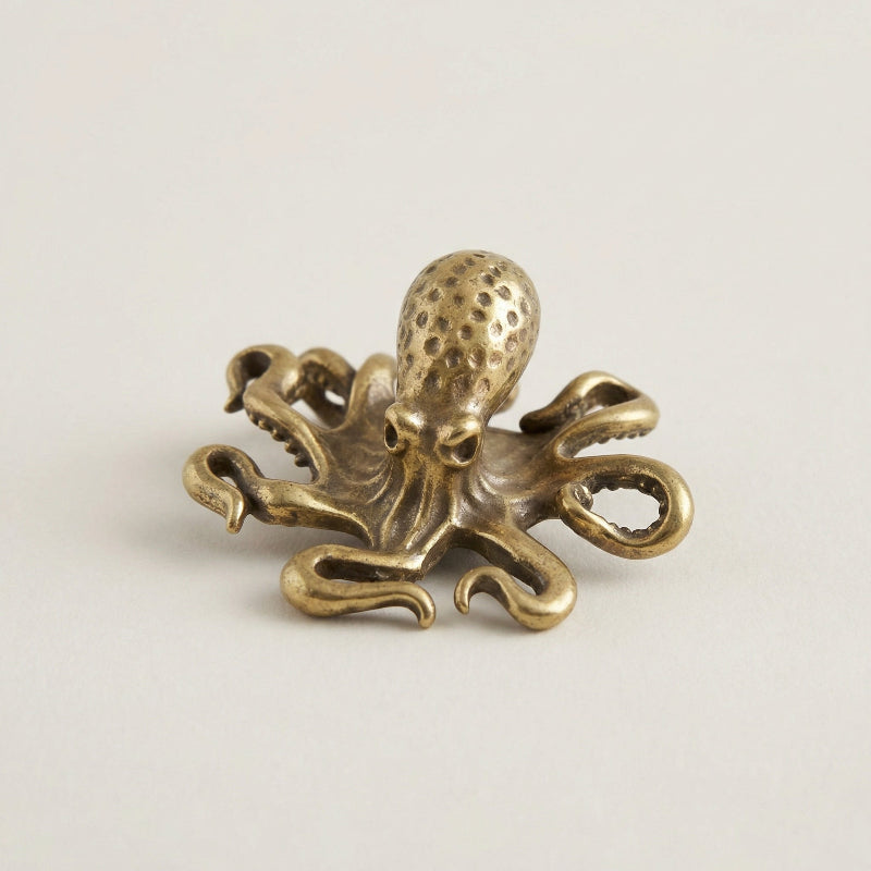 Bronze octopus decorative item on a light beige background