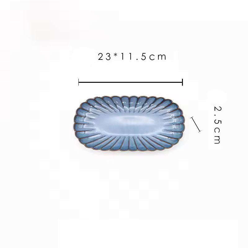 A blue oval ceramic plate with its dimensions labeled as 23 x 11.5 cm and 2.5 cm high.
