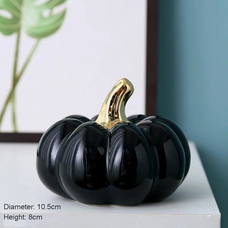 A black ceramic pumpkin with a gold stem.