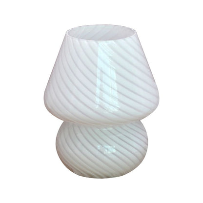 A white striped glass mushroom lamp with a sleek, curved silhouette and diagonal stripes. This modern and minimalist lamp enhances any space with its soft, ambient glow, perfect for cozy home decor.