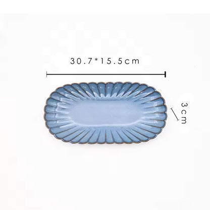 A blue oval ceramic plate with its dimensions labeled as 30.7 x 15.5 cm and 3 cm high.