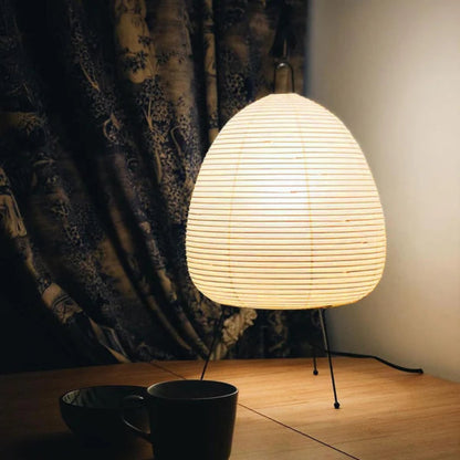 Akari lamp with a clean, geometric shape illuminating a cozy living room.