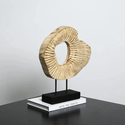 Beautifully crafted wooden sculpture featuring smooth curves and natural woodgrain patterns.