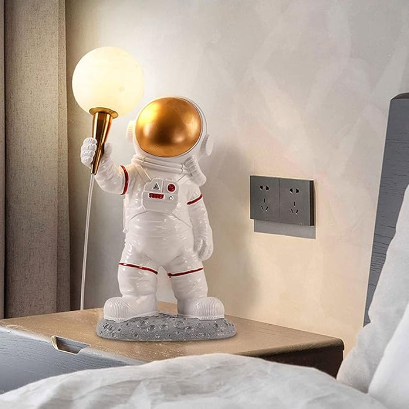 Whimsical astronaut lamp with a glowing helmet, adding a touch of space-themed charm.