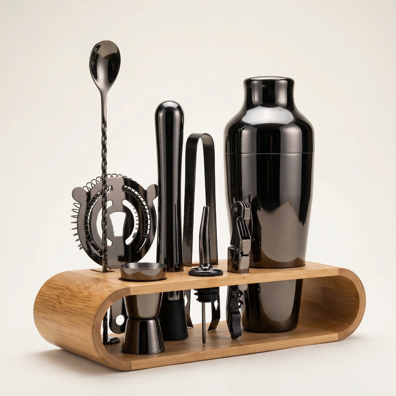 Black 10-piece cocktail bar set with stainless steel tools displayed on a countertop.