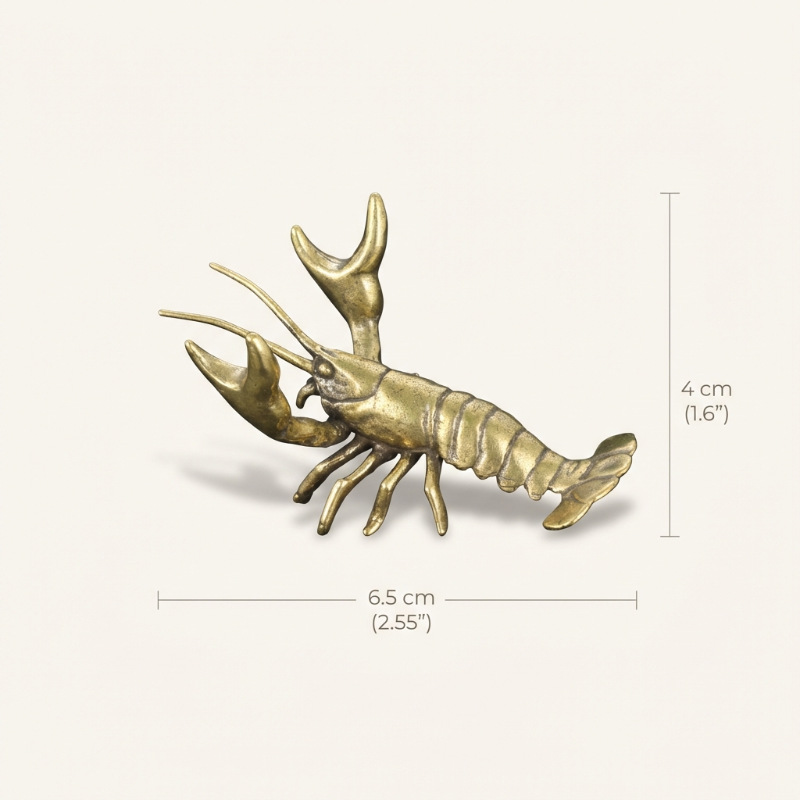 Brass lobster figurine with dimensions on a white background