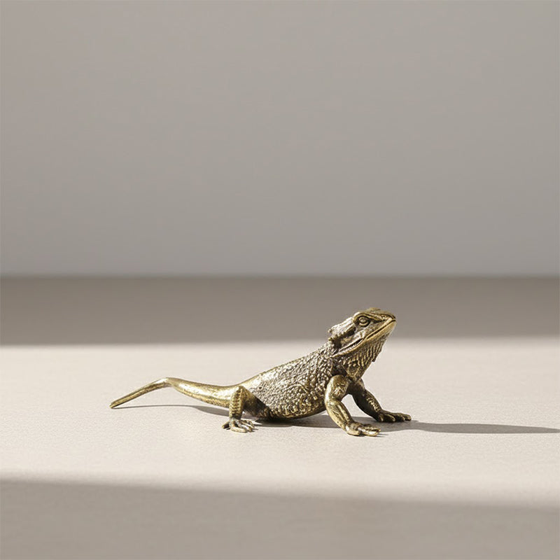 Small brass sculpture of a bearded  lizard.