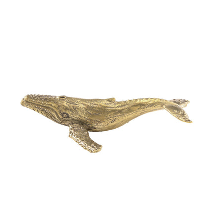 Gold whale figurine on a white background