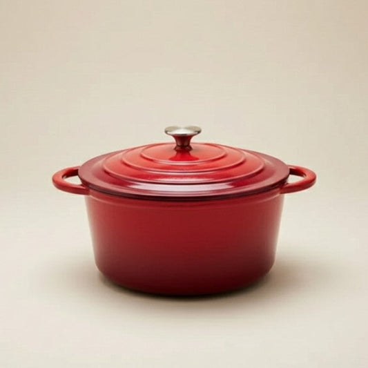 Red enameled cast iron Dutch oven on a beige background