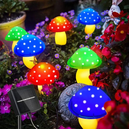 Colorful solar mushroom lights illuminating a garden pathway with a whimsical touch.