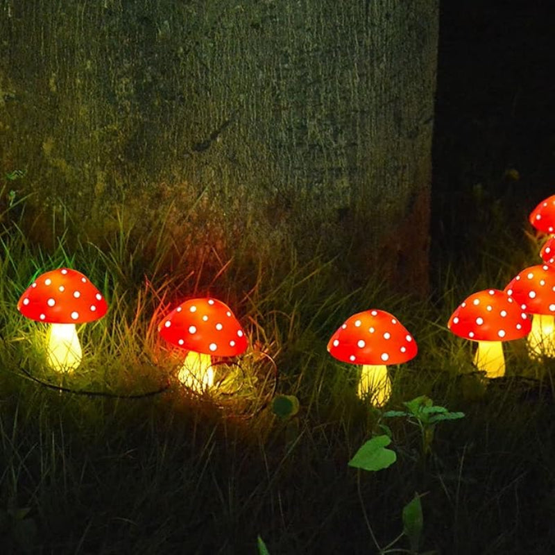 Vibrant solar-powered mushroom lights glowing in various colors, perfect for garden decor.