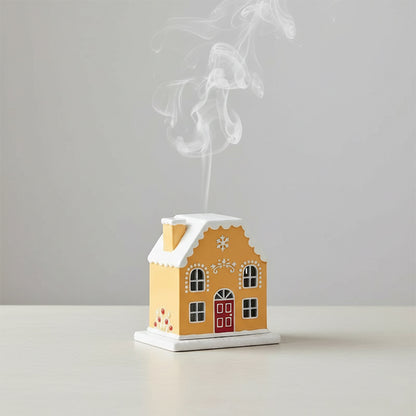 House-shaped incense burner with smoke on a plain background