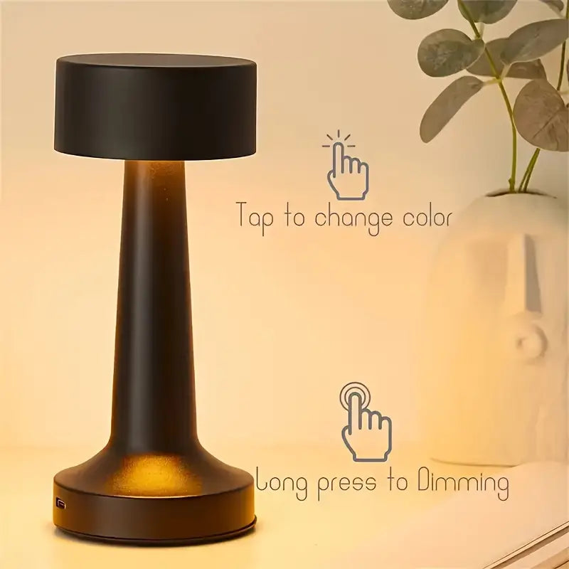 Minimalist cordless table lamp with rechargeable functionality for added convenience and style.