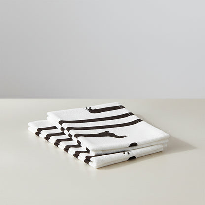 Folded white towel with thick black stripes and a subtle dachshund pattern.