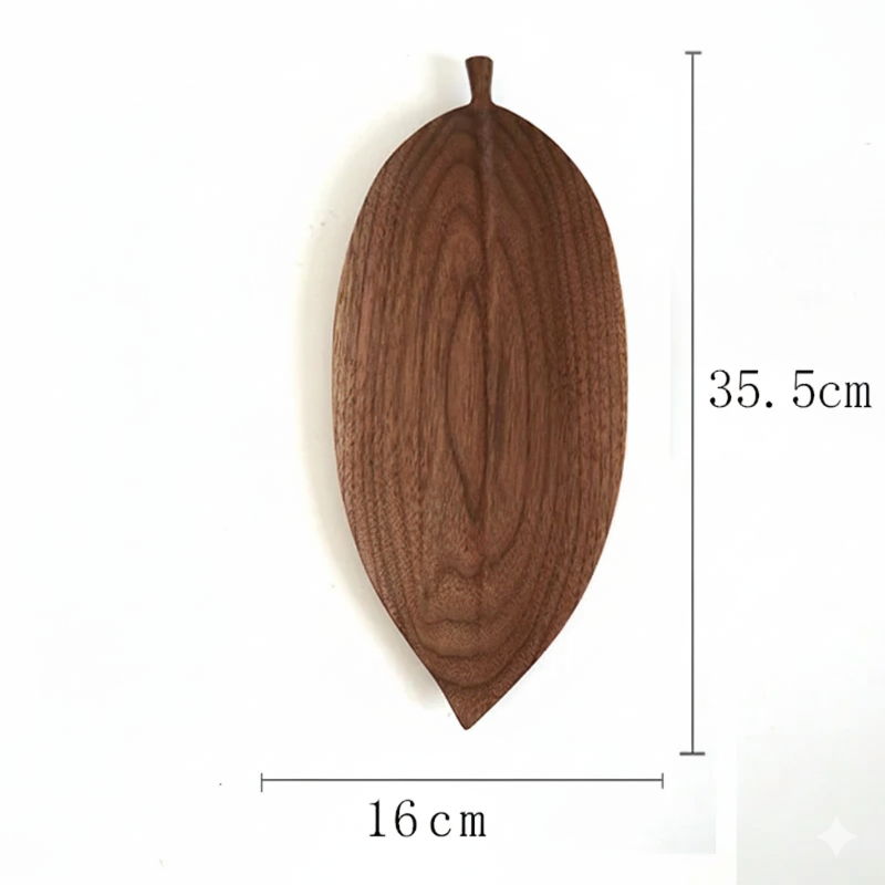 A wooden serving platter shaped like a dark brown, elongated leaf, with dimensions labeled as 35.5cm in height and 16cm in width.