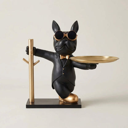 Statue of a dog in a suit holding a tray and a cane on a beige background