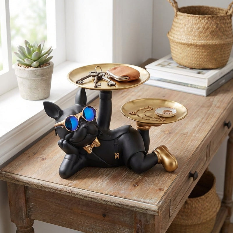 Decorative dog-shaped key holder on a wooden table with books and a plant in the background.