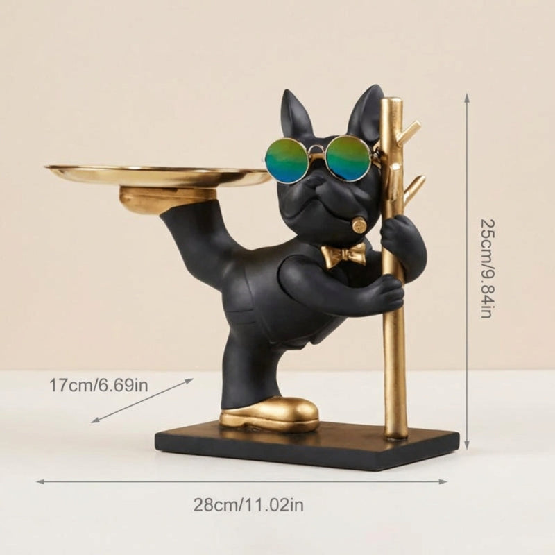 Black dog figurine with sunglasses and a tray, holding a gold cane, on a beige background with measurements indicated.