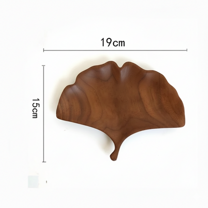 A dark brown wooden decorative tray or dish shaped like a fan-shaped ginkgo leaf, with dimensions marked as 15 CM in height and 19 CM in width, set against a plain white background.