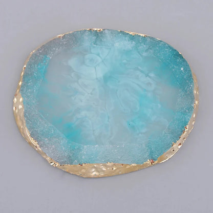 Close-up of a blue resin coaster with a polished surface, adding a cool, calming touch to your dining or coffee table.