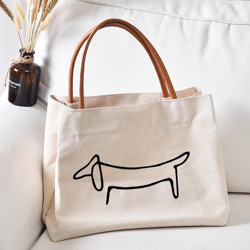 Canvas tote bag with a dog outline.