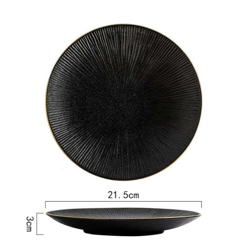 A top-down and side view of a black ceramic plate with a ridged texture and gold rim, showing its dimensions of 21.5cm in diameter and 3cm in height.