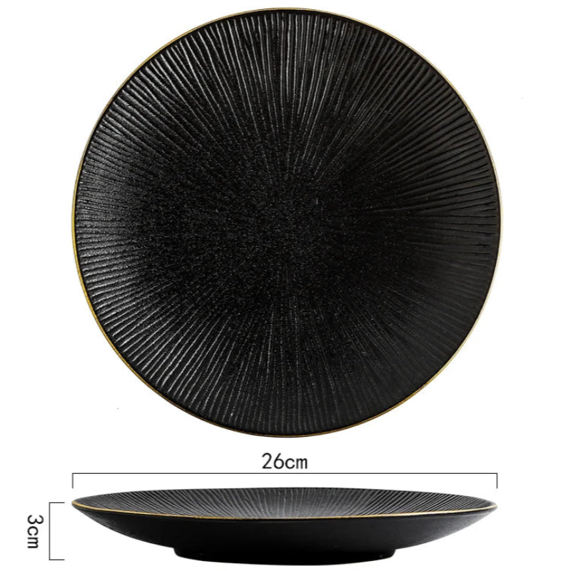 A top-down and side view of a black ceramic plate with a ridged texture and gold rim, showing its dimensions of 26cm in diameter and 3cm in height.