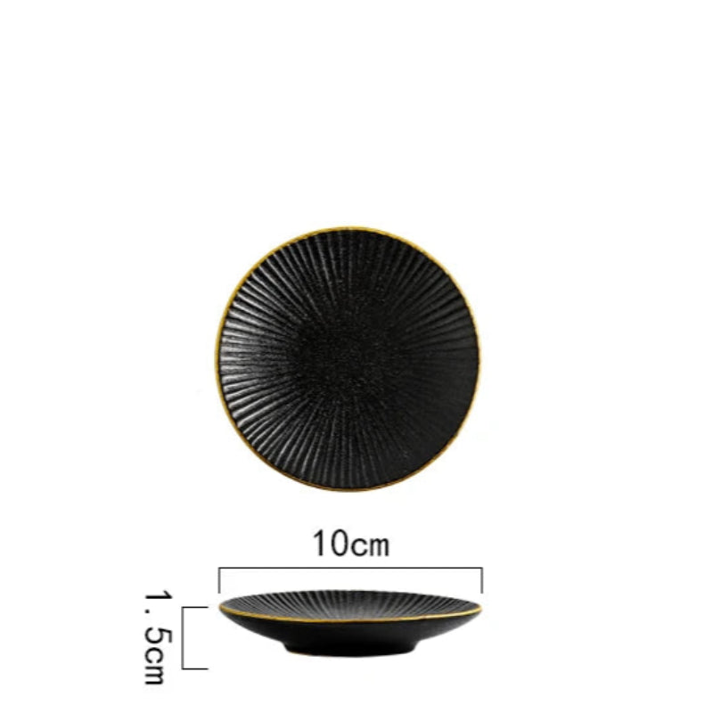 A top-down and side view of a small black ceramic plate with a ridged texture and gold rim, showing its dimensions of 10cm in diameter and 1.5cm in height.